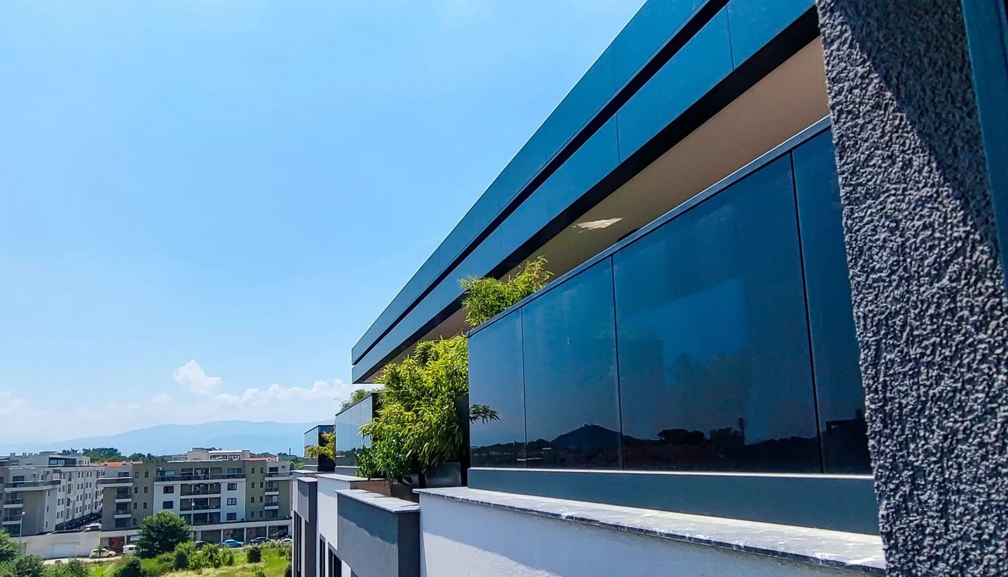Azalia Park building facade with dark architectural glass railings